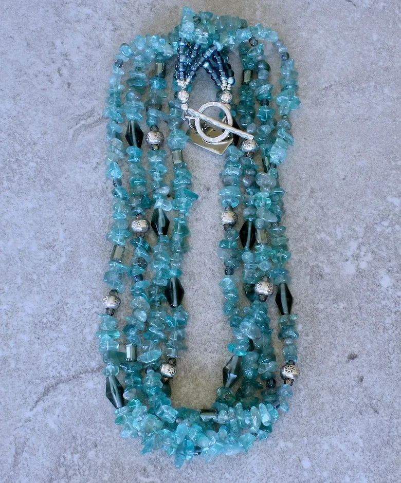 Blue Apatite Nugget 4-Strand Necklace with Montana Blue Czech Glass Rounds, Fire Polished Glass, Translucent Green Crystal Rectangles, Green Glass Faceted Cylinders, and Sterling Silver Rondelle Beads and Toggle Clasp